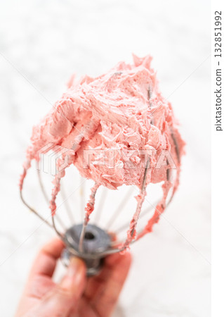 Detailed image of raspberry buttercream on a whisk attachment, showcasing the frosting texture and fluffiness from the Easter Cookie Sandwich with Raspberry Buttercream recipe. Ideal for baking Detailed image of raspberry buttercream on a whisk attachment, showcasing the frosting texture and fluffiness from the Easter Cookie Sandwich with Raspberry Buttercream recipe. Ideal for baking 132851992