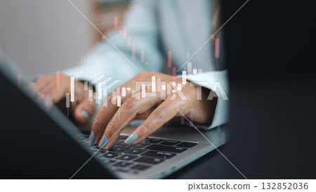 Business person typing on laptop with stock market candlestick chart for financial analysis and trading concept Business person typing on laptop with stock market candlestick chart for financial analysis and trading concept 132852036