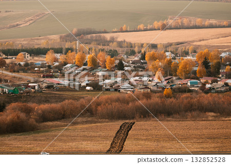 Incredibly beautiful view of the village and autumn fields, viewed from above Incredibly beautiful view of the village and autumn fields, viewed from above 132852528