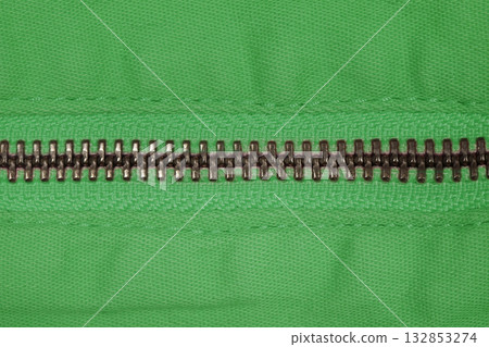 Zipper of green jeans. Close-up of women's jeans, jeans with a zipper. Jeans concept, casual wear concept. 132853274
