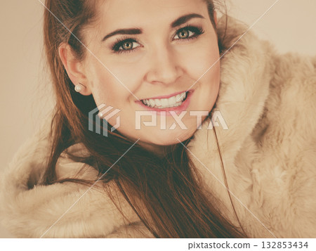 Happy attractive woman wearing furry coat 132853434
