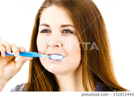 Woman brushing cleaning teeth. 132853448