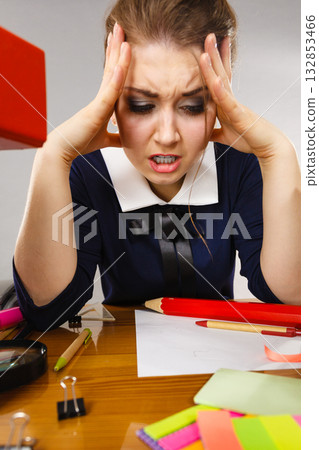 Depressed businesswoman sitting at desk 132853466