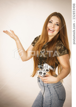 Gamer woman holding gaming pad Gamer woman holding gaming pad 132853498