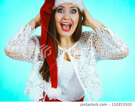 Funny surprised woman in Christmas Santa hat Funny surprised woman in Christmas Santa hat 132853503