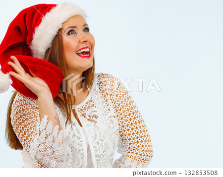 Smiling woman in christmas santa hat 132853508