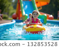 Young girl on water slide at aquapark. Summer holiday. 132853528