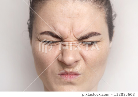 Caucasian woman shows her facial wrinkles on her face. Folds on the skin. Woman winces, Close up Caucasian woman shows her facial wrinkles on her face. Folds on the skin. Woman winces, Close up 132853608