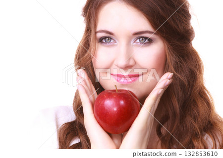 Woman holding apple fruit close to face Woman holding apple fruit close to face 132853610