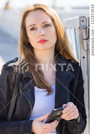Girl using mobile phone texting on smartphone Girl using mobile phone texting on smartphone 132853638