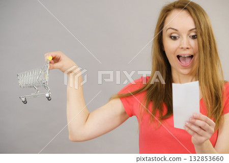Woman with bill and shopping cart 132853660
