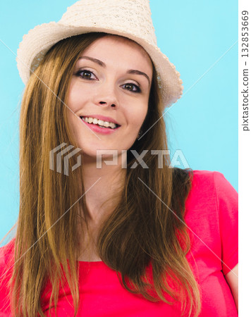 Young adult woman wearing sun hat 132853669