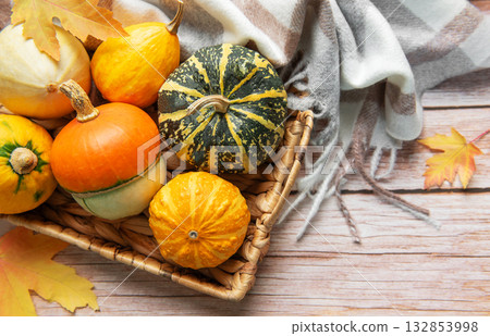 Assorted pumpkins and gourds in an autumn basket Assorted pumpkins and gourds in an autumn basket 132853998