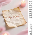 Crumpled paper with be mine message, pink candle nearby. 132854202