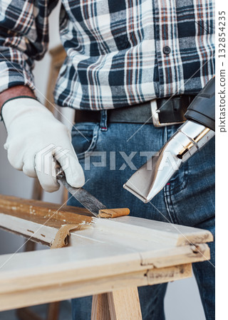 Carpenter at work, restoring an old wooden window. Carpentry. Carpenter at work, restoring an old wooden window. Carpentry. 132854235