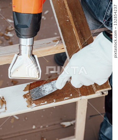 Carpenter at work, restoring an old wooden window. Carpentry. Carpenter at work, restoring an old wooden window. Carpentry. 132854237
