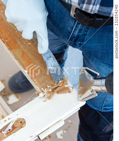 Carpenter at work, restoring an old wooden window. Carpentry. Carpenter at work, restoring an old wooden window. Carpentry. 132854240