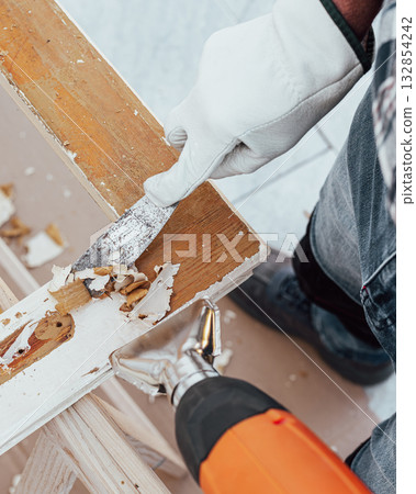 Carpenter at work, restoring an old wooden window. Carpentry. Carpenter at work, restoring an old wooden window. Carpentry. 132854242
