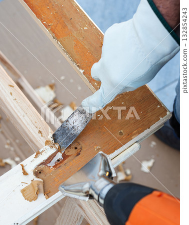 Carpenter at work, restoring an old wooden window. Carpentry. 132854243