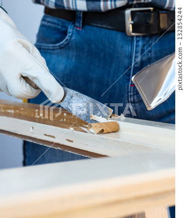 Carpenter at work, restoring an old wooden window. Carpentry. Carpenter at work, restoring an old wooden window. Carpentry. 132854244