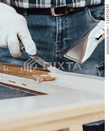Carpenter at work, restoring an old wooden window. Carpentry. 132854245