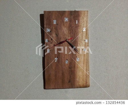 Handcrafted Wooden Wall Clock with Minimalist Design on Brown Background Handcrafted Wooden Wall Clock with Minimalist Design on Brown Background 132854436