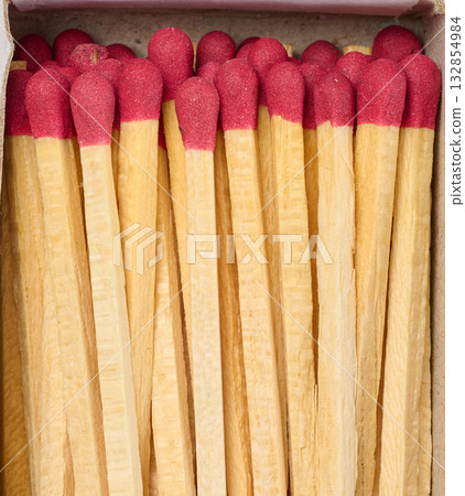Open box of wooden matches with red heads, top view 132854984