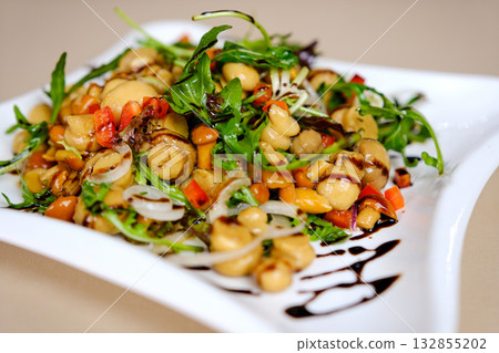 mushrooms with arugula Warm mushroom salad with feta cheese and arugula on a linen napkin. 132855202