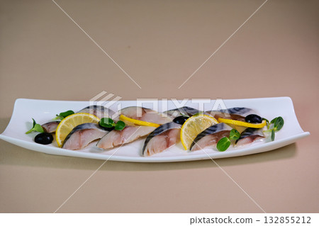 Fresh Mackerel Sashimi Served on Ice with Lemon and Garnishes Fresh Mackerel Sashimi Served on Ice with Lemon and Garnishes 132855212