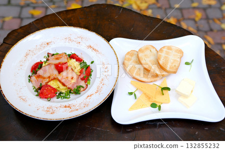 breakfast: omelette with bacon and bread with cheese and butter simple breakfast set of omelettes and chicken nuggets with toast on the table breakfast: omelette with bacon and bread with cheese and butter simple breakfast set of omelettes and chicken nuggets with toast on the table 132855232