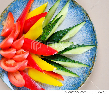 Colorful vegetable snack platter with fresh celery sticks, carrot sticks, red bell pepper, and creamy hummus dip in a glass bowl. Colorful vegetable snack platter with fresh celery sticks, carrot sticks, red bell pepper, and creamy hummus dip in a glass bowl. 132855248