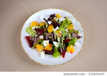 salad with orange, beetroot and feta cheese Fresh Autumn salad rocket leaves, lemon tahini salad dressing. Healthy Vegetarian diet meal concept. Seasonal autumn warm salad recipe salad with orange, beetroot and feta cheese Fresh Autumn salad rocket leaves, lemon tahini salad dressing. Healthy Vegetarian diet meal concept. Seasonal autumn warm salad recipe 132855447