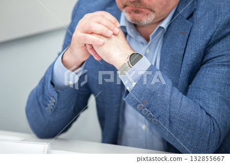 Businessmen unrecognizable man in blue business suit folded his hands. Businessmen unrecognizable man in blue business suit folded his hands. 132855667
