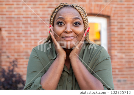 Portrait of african american woman expressing amazement with face gesture. Humor, surprise and emotional authenticity in candid moment. 132855713