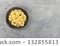 Scrambled eggs with microgreens on gray background. Breakfast concept. Top view. Copy space. 132855813