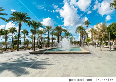 City square with a fountain and tall palm trees on the seafront promenade of Ibiza, Spain City square with a fountain and tall palm trees on the seafront promenade of Ibiza, Spain 132856136