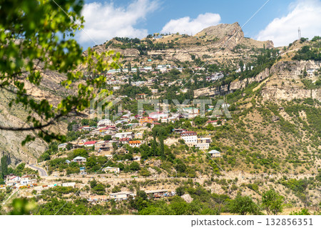 Village of Goor in Dagestan. Facades of houses located in tiers on a steep slope, summer landscape. Village of Goor in Dagestan. Facades of houses located in tiers on a steep slope, summer landscape. 132856351
