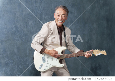 Senior man playing electric guitar Senior man playing electric guitar 132858098