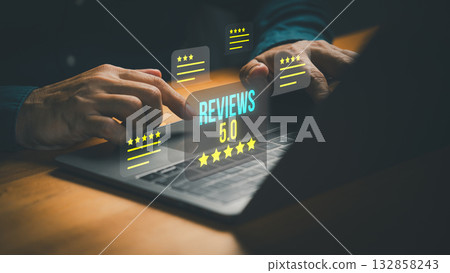 Customer using laptop computer with glowing 5 star review icons, symbolizing positive customer feedback, testimonial, online ratings and excellent service reputation in digital business platform. 132858243