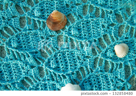 Hand-knitted blue cotton scarf with seascape of fish and shells on it Hand-knitted blue cotton scarf with seascape of fish and shells on it 132858480