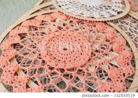 Pink cotton crochets dream catcher are lying on table 132858519
