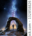 Man standing under a rocky arch formation 132858826