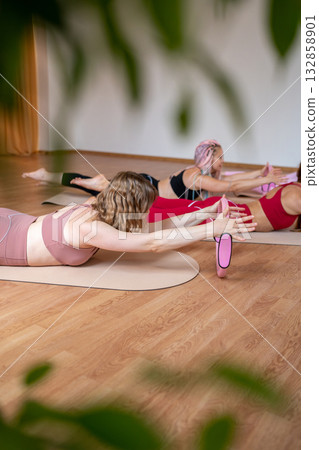 Exercises with pilates ring. Woman doing aerobics workout at pilates studio with panoramic windows. Exercises with pilates ring. Woman doing aerobics workout at pilates studio with panoramic windows. 132858901