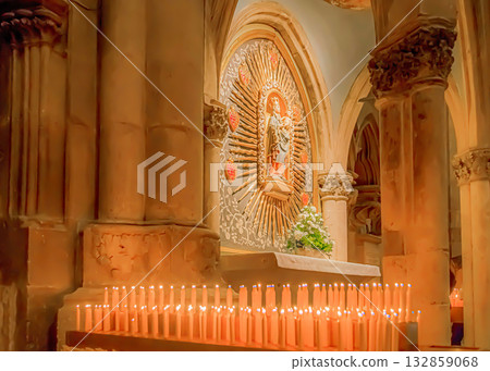 Serene church interior with lit candles Serene church interior with lit candles 132859068