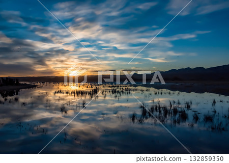 Serene sunset over reflective water 132859350