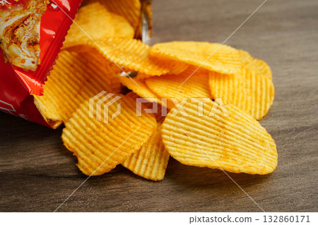 Potato chips , delicious BBQ seasoning spicy for crips, thin slice deep fried snack fast food. Potato chips , delicious BBQ seasoning spicy for crips, thin slice deep fried snack fast food. 132860171