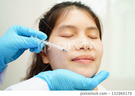 Asian woman receiving filler beauty injection. 132860178