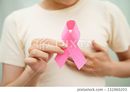 Asian woman with pink ribbon for October world breast cancer day. Asian woman with pink ribbon for October world breast cancer day. 132860203