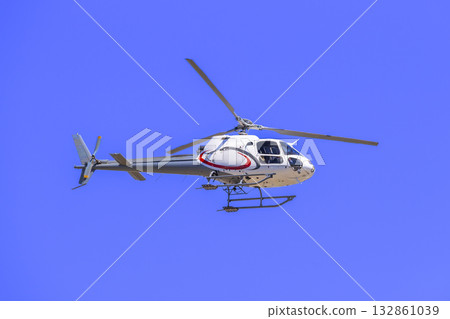 A tourist helicopter in flight around a sporting event A tourist helicopter in flight around a sporting event 132861039