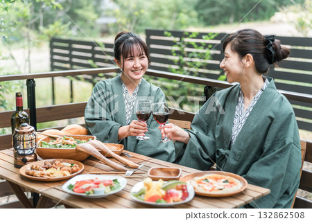 Young Asian woman on a girls trip to a Japanese inn/hot spring inn eating on a balcony/wooden deck (travel/travel) Young Asian woman on a girls trip to a Japanese inn/hot spring inn eating on a balcony/wooden deck (travel/travel) 132862508
